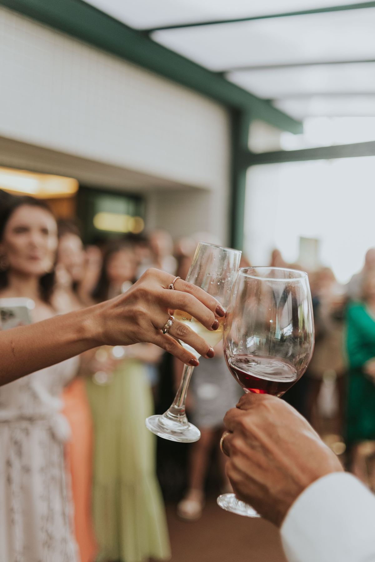 Two people toasting glasses of wine at a celebration